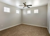 Thumbnail 37 of 42 - Welcome to your serene bedroom, complete with a ceiling fan and bright windows for a perfect blend of comfort and natural light at Trevi Apartment Homes, Chandler, AZ, 85224