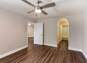 Thumbnail 29 of 32 - Indulge in the allure of hardwood floors and the gentle breeze of a ceiling fan in our cozy bedroom at Boulders at Lookout Mountain Apartment Homes, Phoenix, AZ 85022