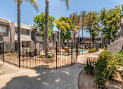 Thumbnail 16 of 19 - a gated community with palm trees and a pool at Scripps Poway Villas, Poway