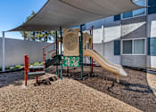 Thumbnail 14 of 28 - Shaded playground area at Sage Creek Apartment Homes, Simi Valley