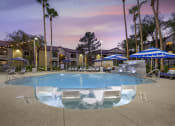 Thumbnail 10 of 29 - As twilight descends, our renovated pool transforms into a magical oasis, beautifully illuminated by soft, ambient lighting.