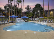 Thumbnail 9 of 29 - The shimmering water reflects the colors of the sunset, creating a serene atmosphere perfect for unwinding after a long day at our updated pool.