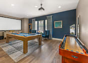 Thumbnail 26 of 50 - The rec room in the clubhouse is perfect for hanging out, featuring a pool table, TV, and shuffleboard for fun and relaxation at Ascent at the Galleria.