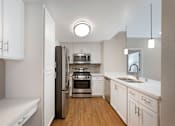 Thumbnail 11 of 50 - Our renovated kitchens shine with stainless steel appliances, upgraded fixtures, and sleek quartz countertops—designed for style and functionality in every Ascent at the Galleria home.