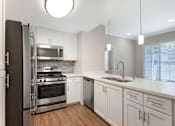 Thumbnail 12 of 50 - Our renovated kitchens open to the living room, creating a spacious flow—perfect for hosting guests and enjoying seamless entertaining at Ascent at the Galleria.