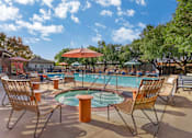 Thumbnail 1 of 30 - A pool area with chairs and umbrellas is shown.