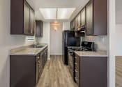 Thumbnail 9 of 21 - Sedona Apartments in Moreno Valley offers renovated units with updated flooring, sleek black appliances, and modern cabinets for stylish, comfortable living.