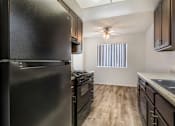 Thumbnail 11 of 21 - Sedona Apartments in Moreno Valley offers renovated units with updated flooring, sleek black appliances, modern cabinets, and stylish ceiling fans.