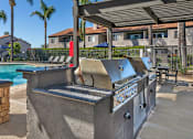 Thumbnail 8 of 21 - Sedona Apartments in Moreno Valley features a renovated pool deck with a gazebo and gas grills—perfect for relaxing and entertaining outdoors.