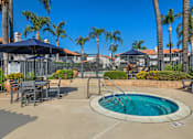 Thumbnail 6 of 21 - Sedona Apartments in Moreno Valley feature a renovated pool deck with a Jacuzzi and covered patio tables—perfect for relaxing or socializing in style.