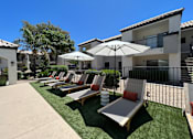 Thumbnail 8 of 32 - Lounge in luxury by our pool deck with plenty of comfy chairs for ultimate relaxation at Boulders at Lookout Mountain Apartment Homes, Phoenix, AZ 85022