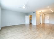 Thumbnail 26 of 46 - A spacious room with a ceiling fan and lighting fixtures.