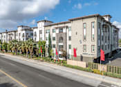 Thumbnail 43 of 46 - A row of modern townhouses with a street in front.