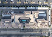 Thumbnail 46 of 46 - An aerial view of a parking lot and a building with a large entrance.