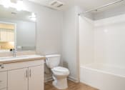 Thumbnail 22 of 46 - A white bathroom with a toilet, sink, and bathtub.