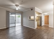 Thumbnail 20 of 29 - This unit features a ceiling fan in the dining room, elegant hardwood floors in the entrance and kitchen, and comes equipped with energy-efficient appliances.at The Hills at Quail Run, Riverside, CA, 