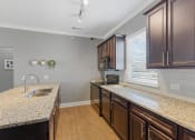 Thumbnail 23 of 31 - Large Kitchen With Granite Counters and Subway Tile BackSpash