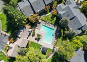 Thumbnail 17 of 28 - arial view of a swimming pool in a neighborhood with houses and trees