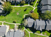 Thumbnail 25 of 28 - an aerial view of a neighborhood with houses and green grass
