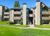 Thumbnail 28 of 28 - an exterior view of an apartment building with a green lawn
