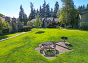 Thumbnail 19 of 28 - a backyard with a picnic table and a fire pit