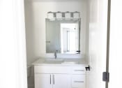 Thumbnail 16 of 28 - a white bathroom with a sink and a mirror