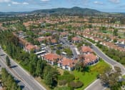 Thumbnail 43 of 48 - an aerial view of a neighborhood with red roofs and green grass at La Serena, San Diego, California