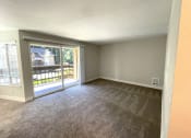 Thumbnail 6 of 18 - an empty living room with a patio door