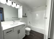 Thumbnail 5 of 18 - an empty bathroom with a sink toilet and shower