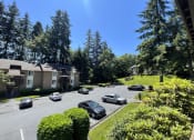 Thumbnail 11 of 18 - an aerial view of a parking lot with cars in front of houses