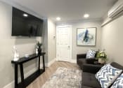 Thumbnail 15 of 18 - a living room with a couch and a tv