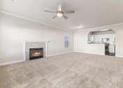 Thumbnail 20 of 41 - a living room with a fireplace and a ceiling fan