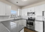 Thumbnail 22 of 41 - Quartz Countertops and Stainless Steel Appliances in Kitchen