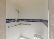 Thumbnail 32 of 48 - a walk in shower with white walls and blue tile at La Serena, San Diego, California