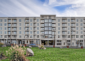 Thumbnail 18 of 37 - a large apartment building with a grassy area in front of it at Link Apartments® Canvas, Georgia