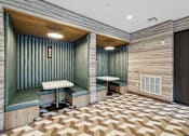 Thumbnail 17 of 33 - a tasting room with two booths and a wooden floor and green walls at Link Apartments® Broad Ave, Tennessee