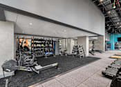 Thumbnail 37 of 39 - A gym with a variety of equipment including weights and cardio machines at Link Apartments® QPN, Long Island City, New York