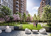 Thumbnail 7 of 34 - a rendering of a courtyard with furniture and a grassy area with trees and buildings in the