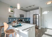 Thumbnail 3 of 24 - Fitted Kitchen With Island Dining at Link Apartments® Glenwood South, Raleigh, NC, 27603