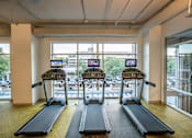 Thumbnail 20 of 24 - Cardio Machines In Gym at Link Apartments® Glenwood South, Raleigh, North Carolina