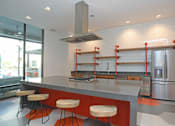 Thumbnail 16 of 44 - Fitted Kitchen With Island Dining at Link Apartments Innovation Quarter, North Carolina