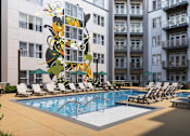 Thumbnail 17 of 25 - A pool area with a large sculpture in front of a building.