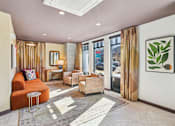 Thumbnail 6 of 33 - a living room with a orange couch and chairs and a window at Link Apartments® Broad Ave, Memphis, Tennessee