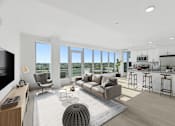 Thumbnail 9 of 32 - an open living room with a couch and a chair and a kitchen with a counter