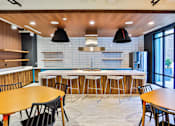 Thumbnail 23 of 48 - Clubhouse Kitchen Breakfast Bar with Stools at Link Apartments® Montford, Charlotte, NC