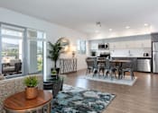 Thumbnail 14 of 28 - A modern living room with a dining area and kitchen in the background.