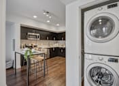 Thumbnail 25 of 28 - A modern kitchen with a washer and dryer built into the cabinetry.