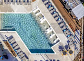 Thumbnail 3 of 18 - A large swimming pool with a staircase leading down to it.