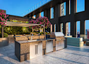 Thumbnail 15 of 34 - A modern outdoor kitchen with a grill and sink.