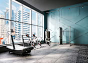 Thumbnail 24 of 34 - A gym with a view of the cityscape outside the large windows.